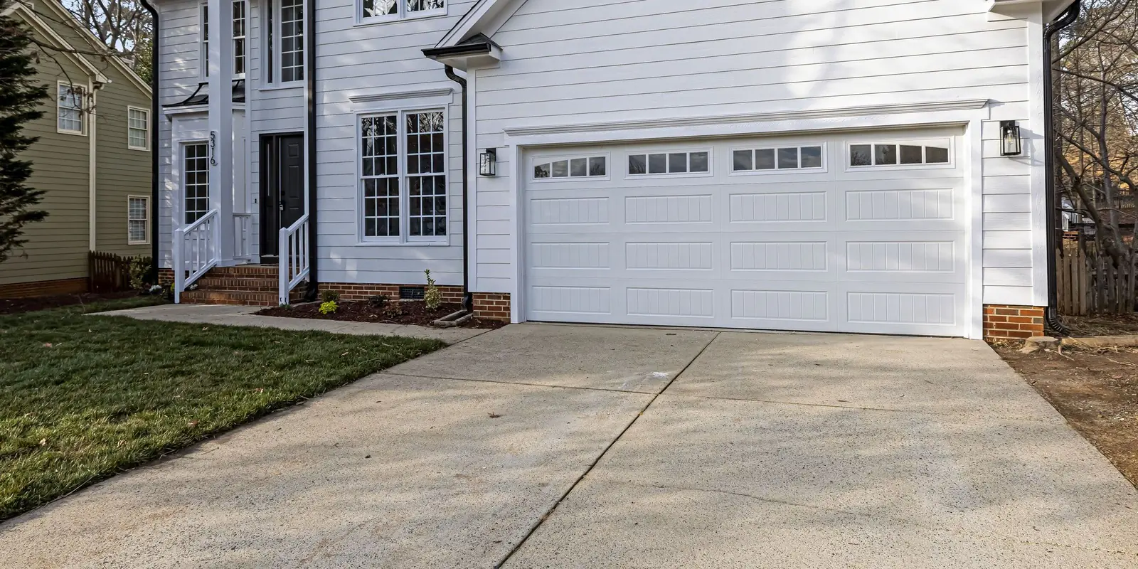 A concrete driveway apron with the walk to the front porch, its boundary drawn.