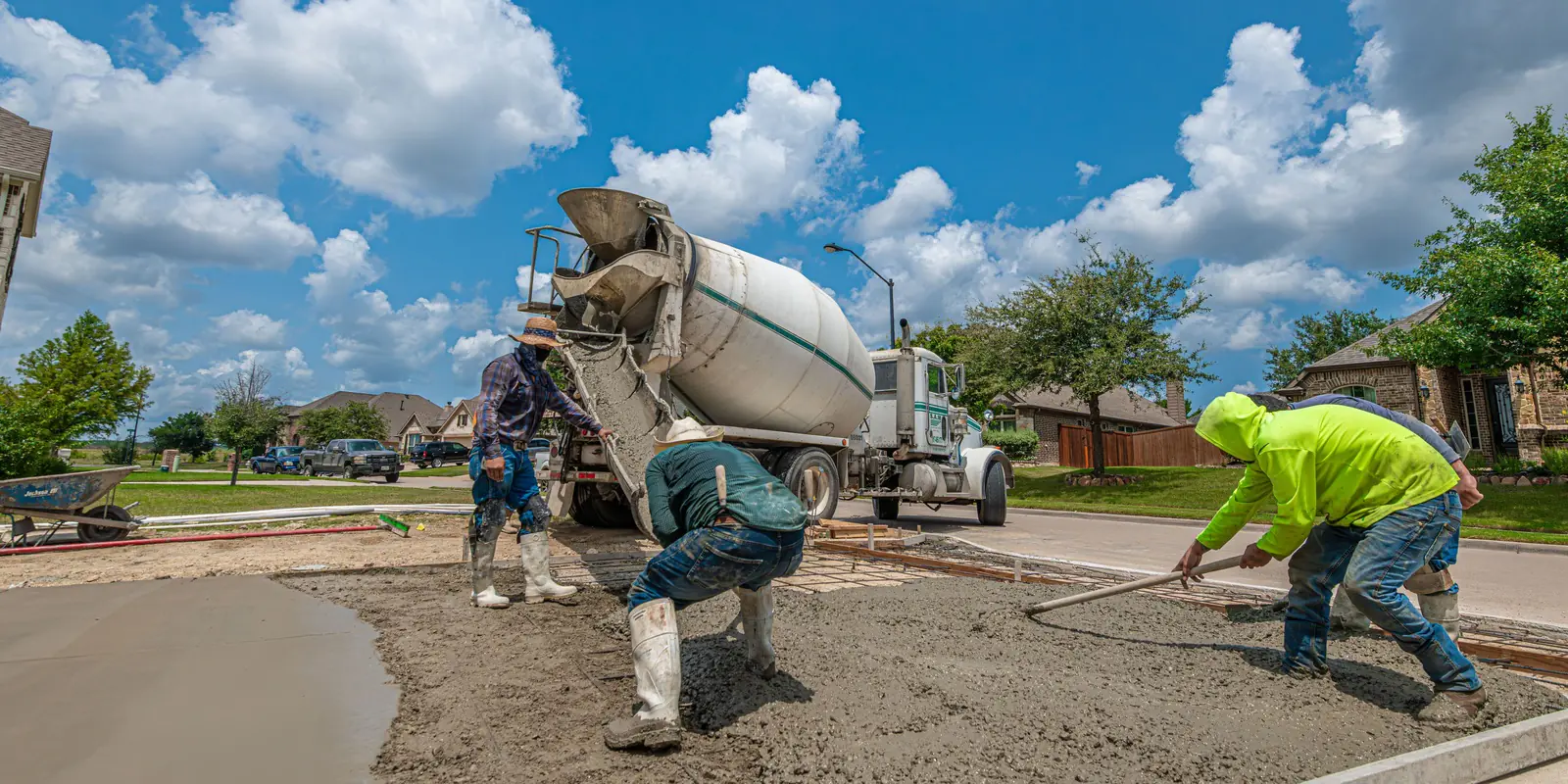 A concrete truck pouring a formed slab, the forms drawn as one outline.